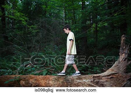 Stock Image - Boy walking on log. Fotosearch