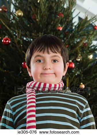 Boy wearing a scarf at christmas View Large Photo Image Stock Photograph - Boy wearing a scarf at christmas. Fotosearch