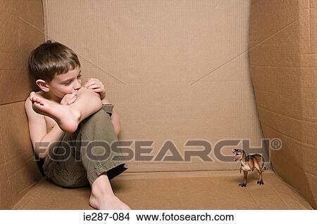 Boy with a toy dinosaur View Large Photo Image Picture - Boy with a toy dinosaur. Fotosearch