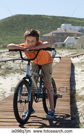 Boy with bicycle View Large Photo Image Picture - Boy with bicycle. Fotosearch