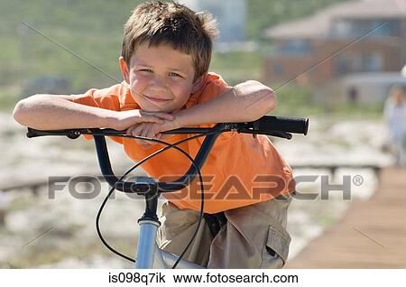 Stock Image - Boy with bicycle. Fotosearch