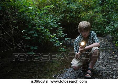 Boy with torch by river View Large Photo Image Picture - Boy with torch by river. Fotosearch
