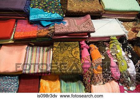 Stock Photo - Bright scarves on shelves in market. Fotosearch