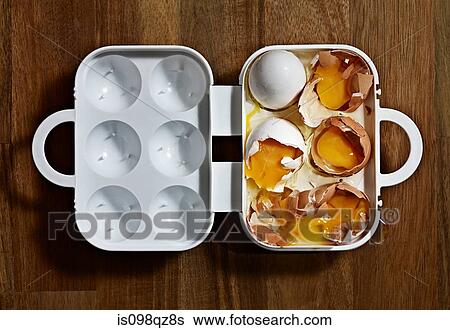 Broken eggs in a carton View Large Photo Image Stock Photograph - Broken eggs in a carton. Fotosearch