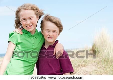 Brother and sister at the coast View Large Photo Image Picture - Brother and sister at the coast. Fotosearch