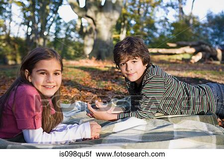 Stock Image - Brother and sister in park. Fotosearch