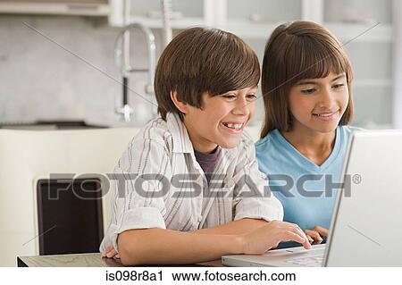 Brother and sister using a laptop computer View Large Photo Image Stock Image - Brother and sister using a laptop computer. Fotosearch