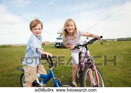 Stock Photo - Brother and sister with bicycles. Fotosearch