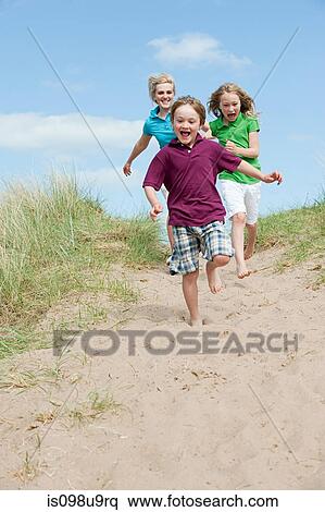 Brother and sisters running to the beach View Large Photo Image Stock Photography - Brother and sisters running to the beach. Fotosearch