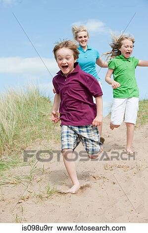 Brother and sisters running to the beach View Large Photo Image Stock Photography - Brother and sisters running to the beach. Fotosearch