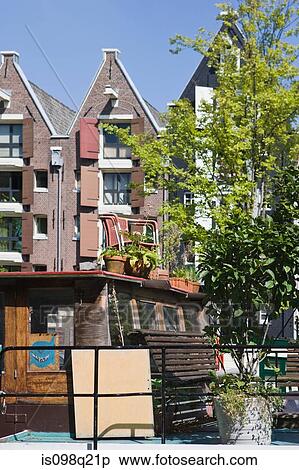 Stock Photography - Building and boat in amsterdam. Fotosearch