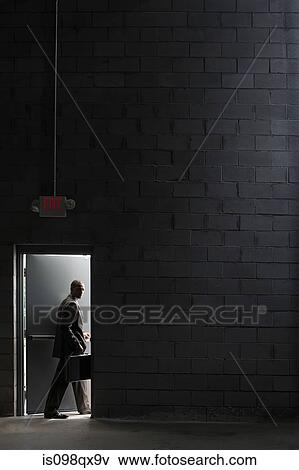 Businessman going through door View Large Photo Image Stock Photo - Businessman going through door. Fotosearch