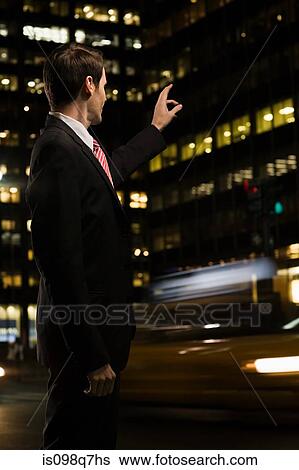 Stock Photograph - Businessman hailing a cab. Fotosearch
