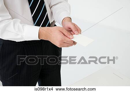 Businessman holding businesscards View Large Photo Image Picture - Businessman holding businesscards. Fotosearch
