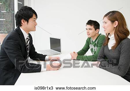 Stock Image - Businessman in a meeting with clients. Fotosearch