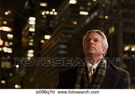 Businessman in the city at night View Large Photo Image Stock Image - Businessman in the city at night. Fotosearch