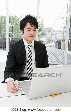 Businessman using a laptop View Large Photo Image Stock Image - Businessman using a laptop. Fotosearch