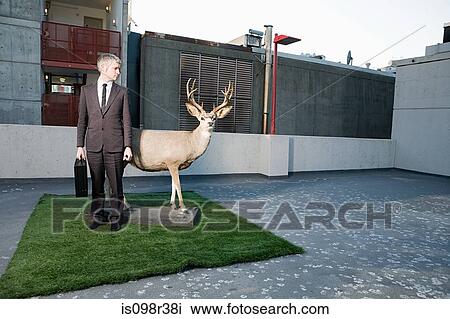 Stock Image - Businessman with deer. Fotosearch