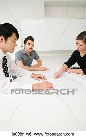 Businesspeople in a meeting View Large Photo Image Stock Photograph - Businesspeople in a meeting. Fotosearch