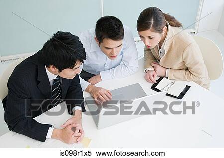 Stock Photography - Businesspeople in a meeting. Fotosearch
