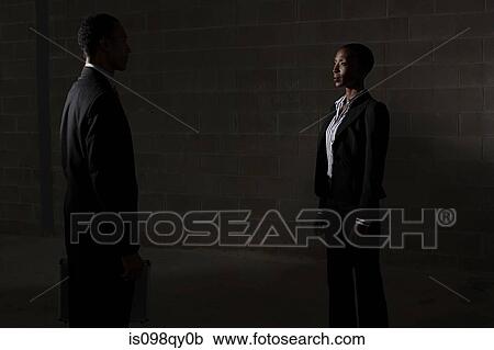 Stock Image - Businesspeople in warehouse. Fotosearch