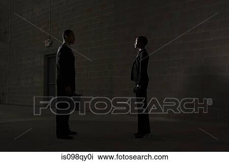 Stock Image - Businesspeople in warehouse. Fotosearch
