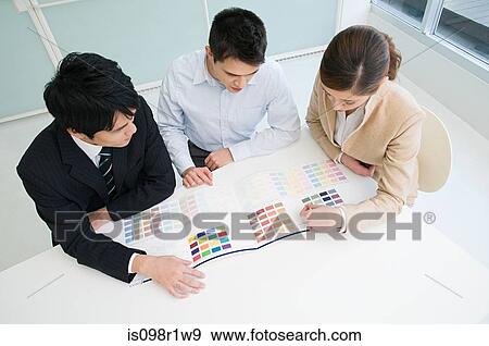 Businesspeople looking at a chart View Large Photo Image Stock Photo - Businesspeople looking at a chart. Fotosearch