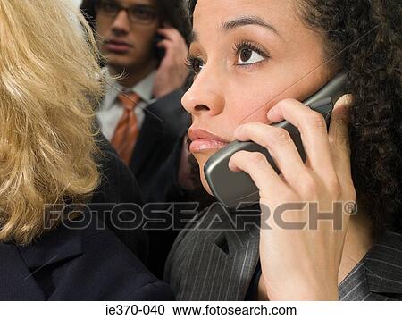 Businesspeople on cellphones View Large Photo Image Stock Image - Businesspeople on cellphones. Fotosearch