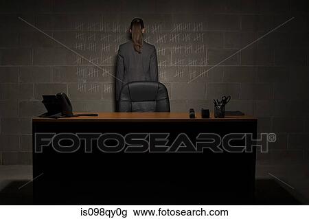 Stock Image - Businesswoman and chalk marks on wall. Fotosearch