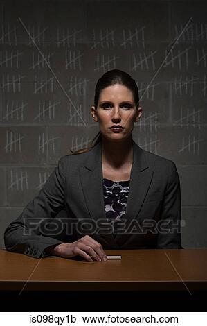 Stock Image - Businesswoman and chalk marks on wall. Fotosearch