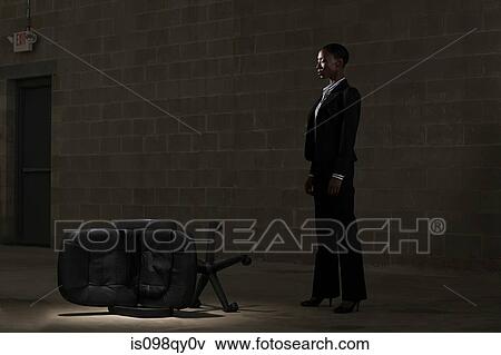 Stock Photo - Businesswoman and fallen chair. Fotosearch