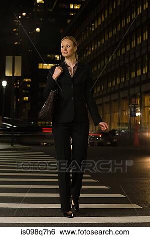 Stock Photograph - Businesswoman crossing the street. Fotosearch