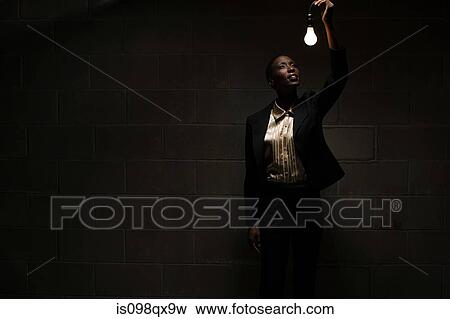 Businesswoman holding lightbulb View Large Photo Image Stock Photo - Businesswoman holding lightbulb. Fotosearch