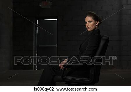 Stock Image - Businesswoman in chair. Fotosearch