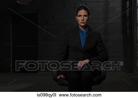 Stock Image - Businesswoman in chair. Fotosearch