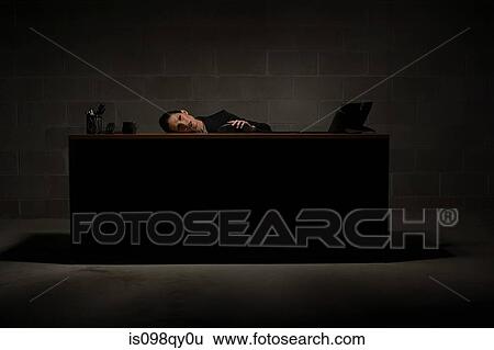 Stock Photograph - Businesswoman leaning on desk. Fotosearch