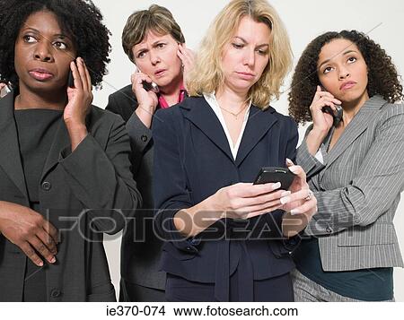 Businesswomen with cellphones View Large Photo Image Picture - Businesswomen with cellphones. Fotosearch