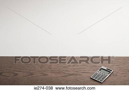 Stock Photo - Calculator on desk. Fotosearch