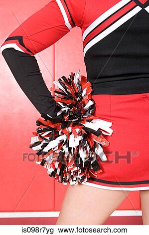 Stock Image - Cheerleader with pom pom. Fotosearch