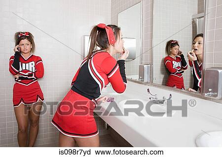 Stock Image - Cheerleaders in restroom. Fotosearch