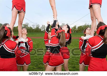 Cheerleaders performing routine View Large Photo Image Stock Image - Cheerleaders performing routine. Fotosearch