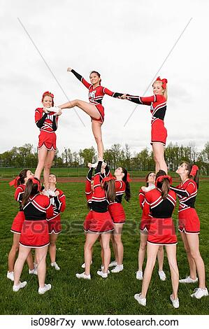 Cheerleaders performing routine View Large Photo Image Stock Photo - Cheerleaders performing routine. Fotosearch