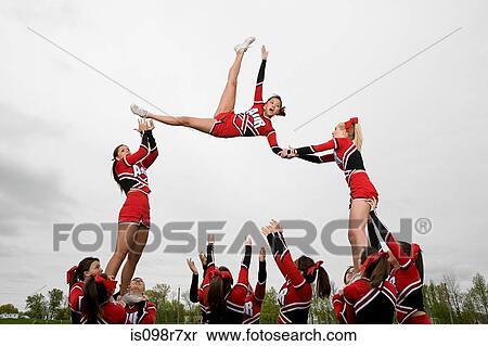 Stock Photography - Cheerleaders performing routine. Fotosearch