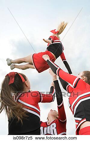 Stock Photography - Cheerleaders performing routine. Fotosearch