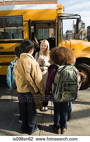 Children and teacher by school bus View Large Photo Image Stock Image - Children and teacher by school bus. Fotosearch