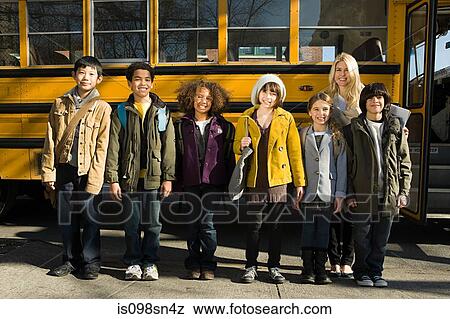 Stock Photo - Children and teacher by school bus. Fotosearch