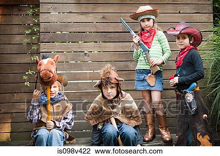 Stock Image - Children dressed up as cowgirl, bear and cowboys. Fotosearch