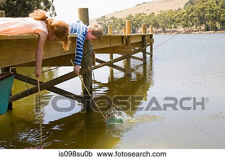 Stock Image - Children enjoying lakeside vacation. Fotosearch