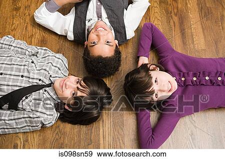 Children lying on floor View Large Photo Image Stock Photo - Children lying on floor. Fotosearch