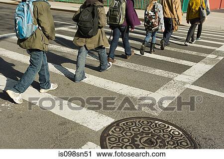 Stock Image - Children walking across road. Fotosearch
